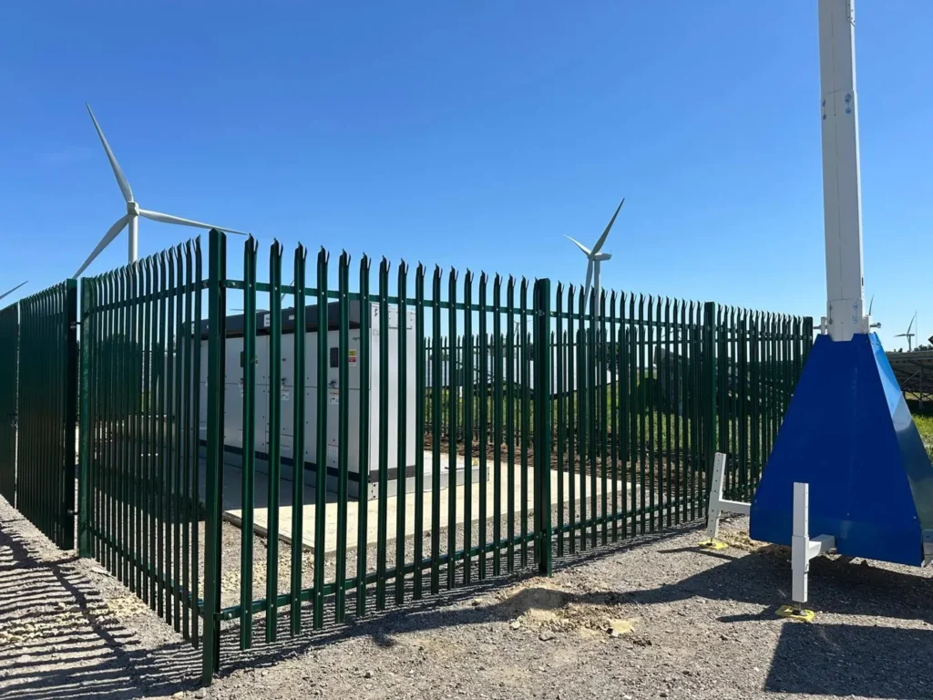Palisade compound and gates around the inverters at Coldham Solar Farm
